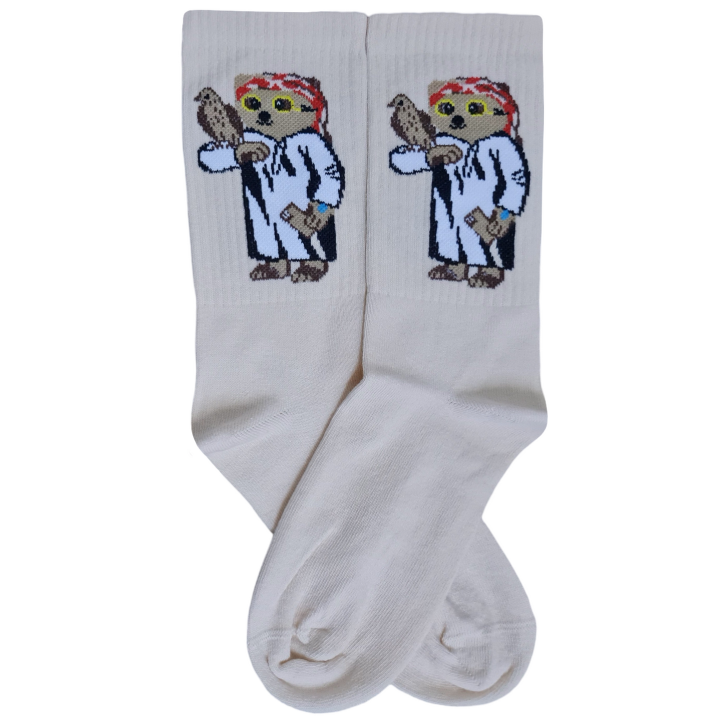 A pair of white socks with a design of a dog wearing a thobe and holding a falcon, with a shemagh pattern in the background.