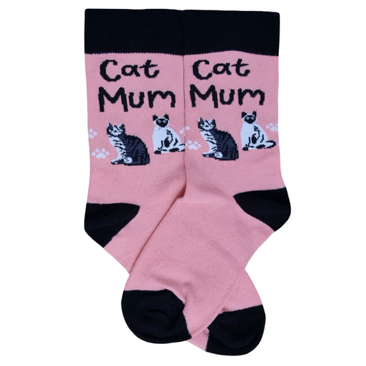 Pink crew socks with a black top cuff, heel, and toe, featuring the text "Cat Mum" above two illustrated cats and white paw prints.
