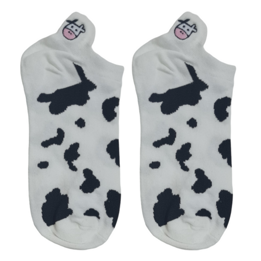 White short socks featuring black cow spots and a cute embroidered cow face with pink cheeks near the toes.