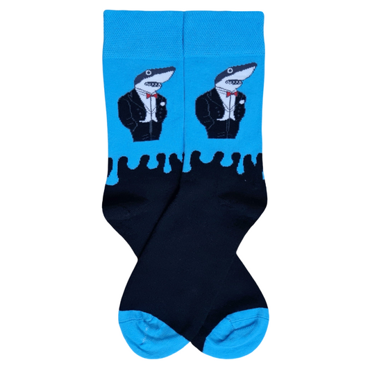 Blue crew socks featuring a shark wearing a black tuxedo and red bow tie, with black lower sections and blue heels and toes.