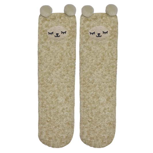 A pair of beige fluffy socks with cartoon llamfaces and ears on the top.a 