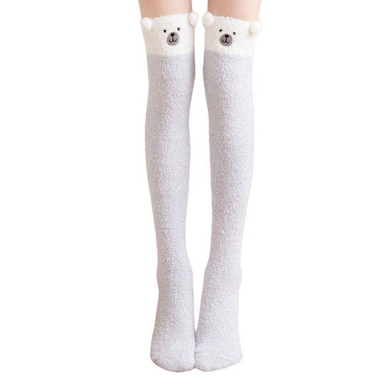 White knee-high socks with bear ears and face on a white background
