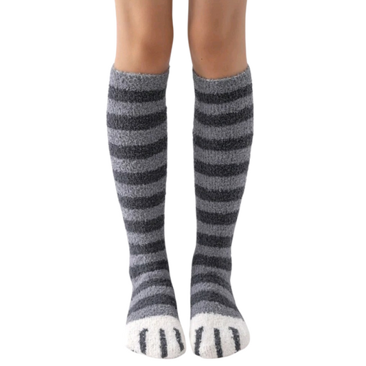 Knee-high socks with gray and white striped pattern worn by a person on a white background