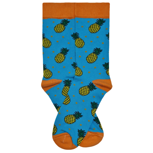 Pair of bright blue crew socks with orange cuffs and toes, featuring a repeating yellow pineapple pattern with small orange polka dots.