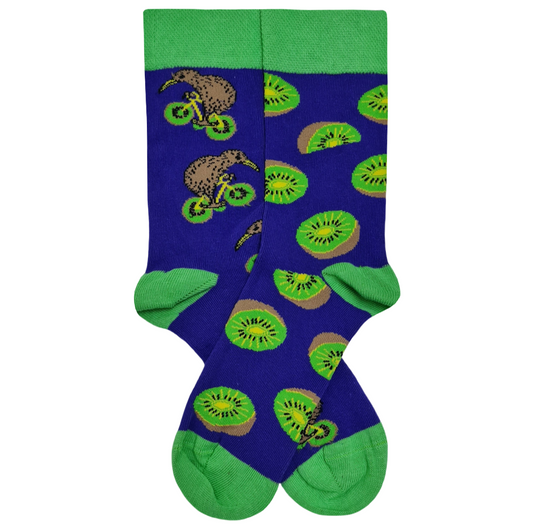 Mismatched blue crew socks featuring a kiwi bird riding a bicycle on one side and sliced kiwi fruit patterns on the other with green accents.