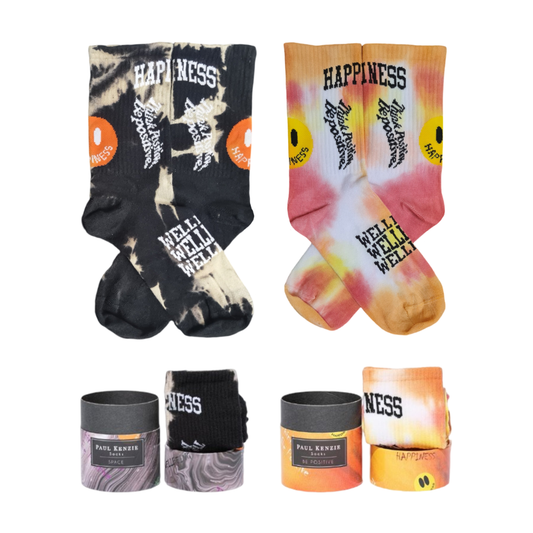 A 2-pack sock set featuring one black and white tie-dye crew sock pair and one orange, yellow, and red tie-dye pair, both displayed with round gift packaging boxes.
