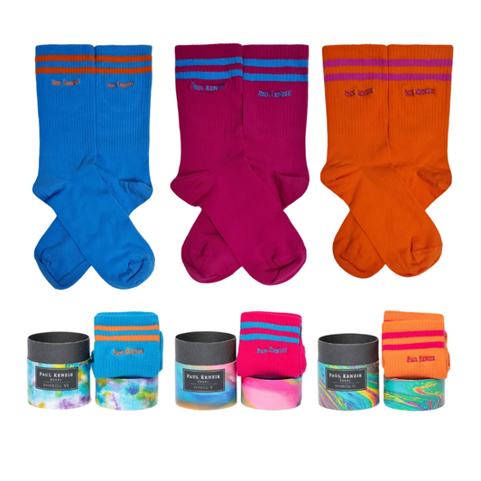 A 3-pack ribbed crew sock set featuring blue, magenta, and orange socks with contrasting double stripes at the top, shown with cylindrical gift boxes.