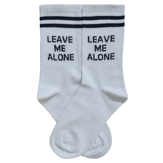 White socks with 'Leave Me Alone' text on a white background